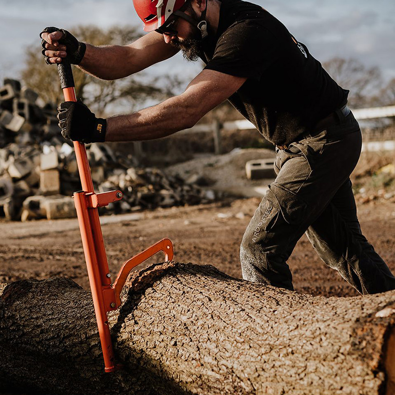 man turning log over with the timber jack